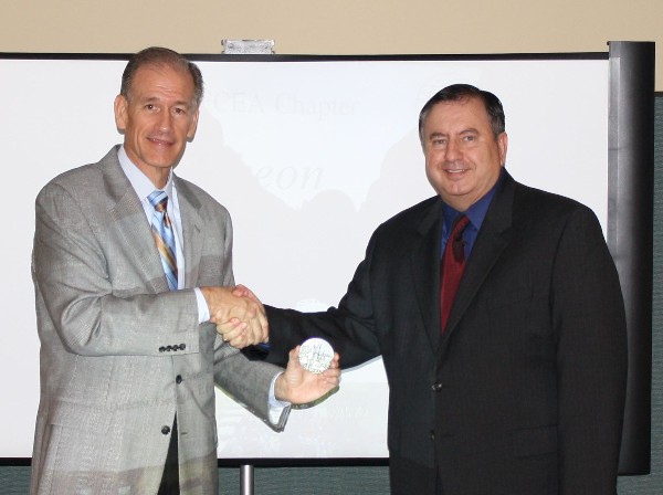David Landry (r), chapter second vice president, presents Charley English, director of the Georgia Emergency Management Agency, with a token of appreciation at the September meeting.